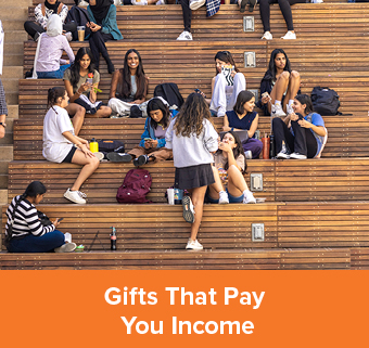 Students standing on some bleachers. Gifts That Pay You Income Rollover